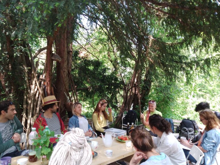 people sitting around a table outside