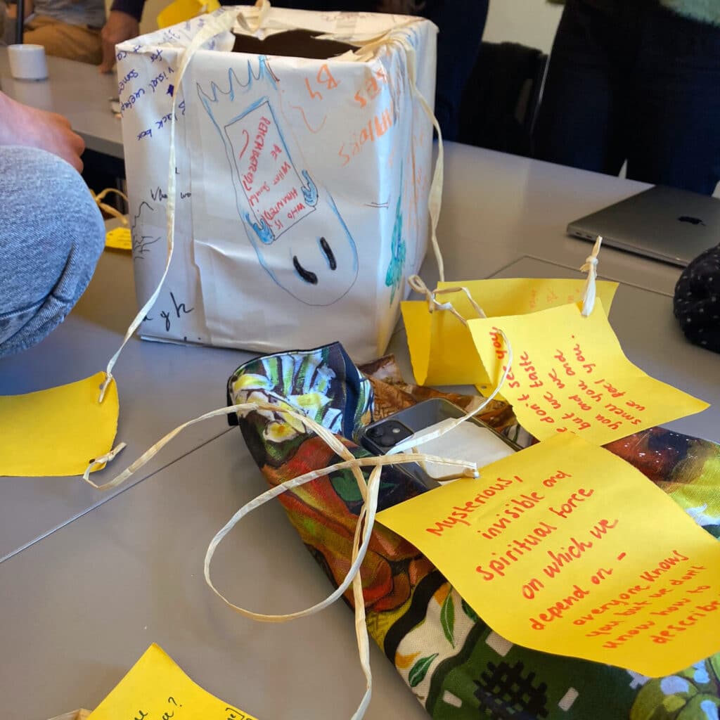 a box and some yellow papers, connected by a string