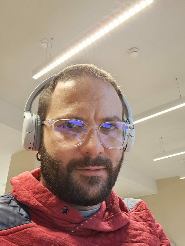 person with headphones looking into the camera